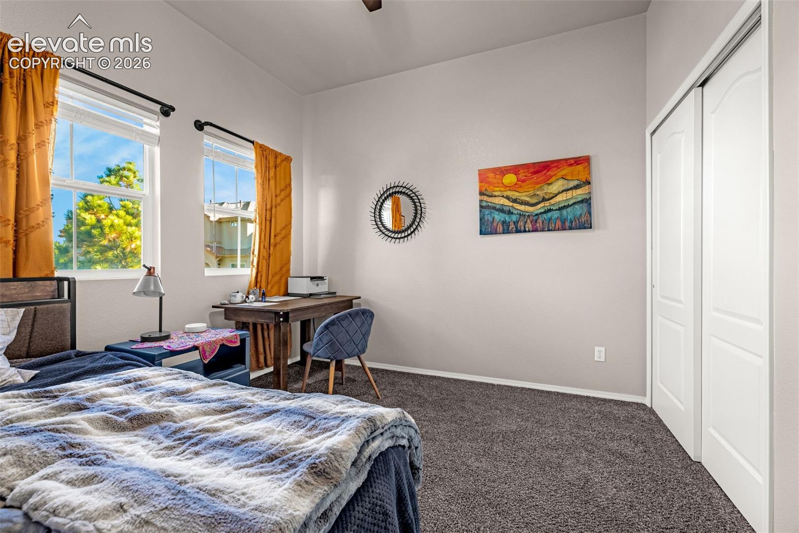 Dual windows with natural light, high ceilings, neutral wall tones, wall-to-wall carpeting, and sliding-panel closet doors
