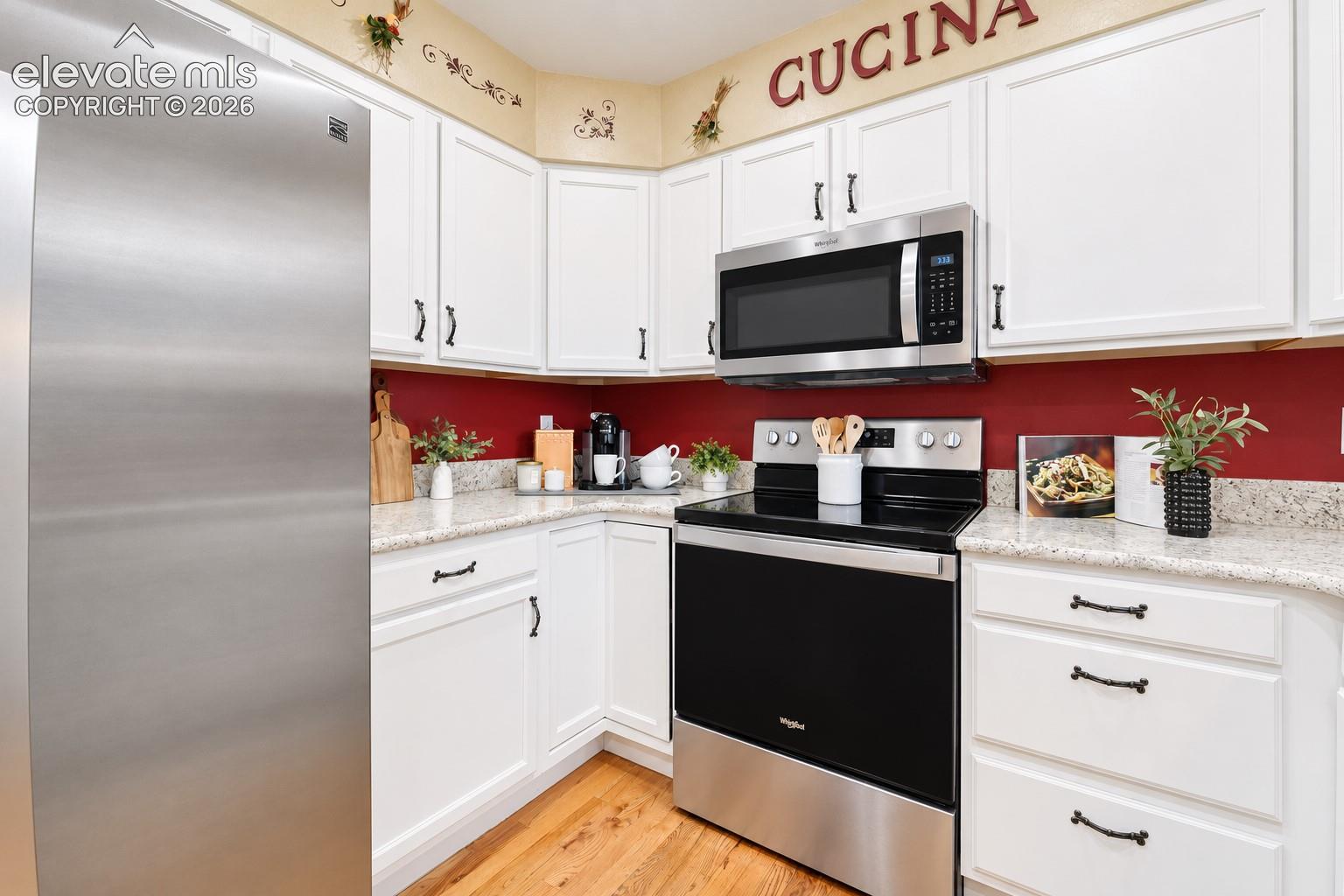 Stainless steel appliances in the Kitchen feature a smooth top range oven, built-in microwave oven, dishwasher, and refrigerator.
