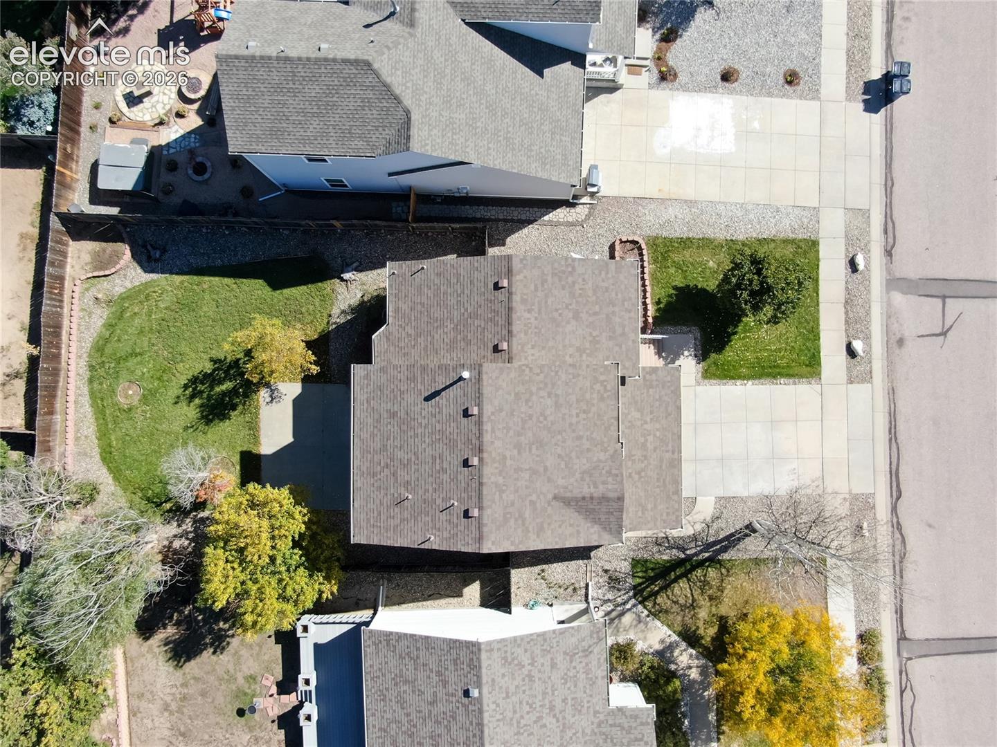 A direct aerial view showcases the wonderful curb appeal of this move-in ready home. The property includes a paved concrete driveway, elevated entry porch, and crisp architectural detailing