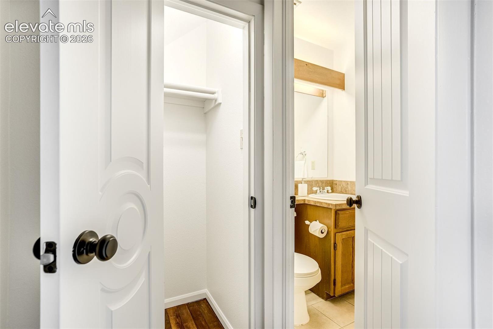 Convenient half-bath and under stairs storage 