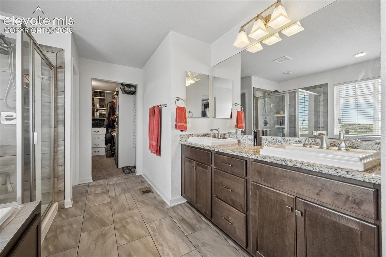 Dual vanity with vessel sinks and granite-finish countertops
