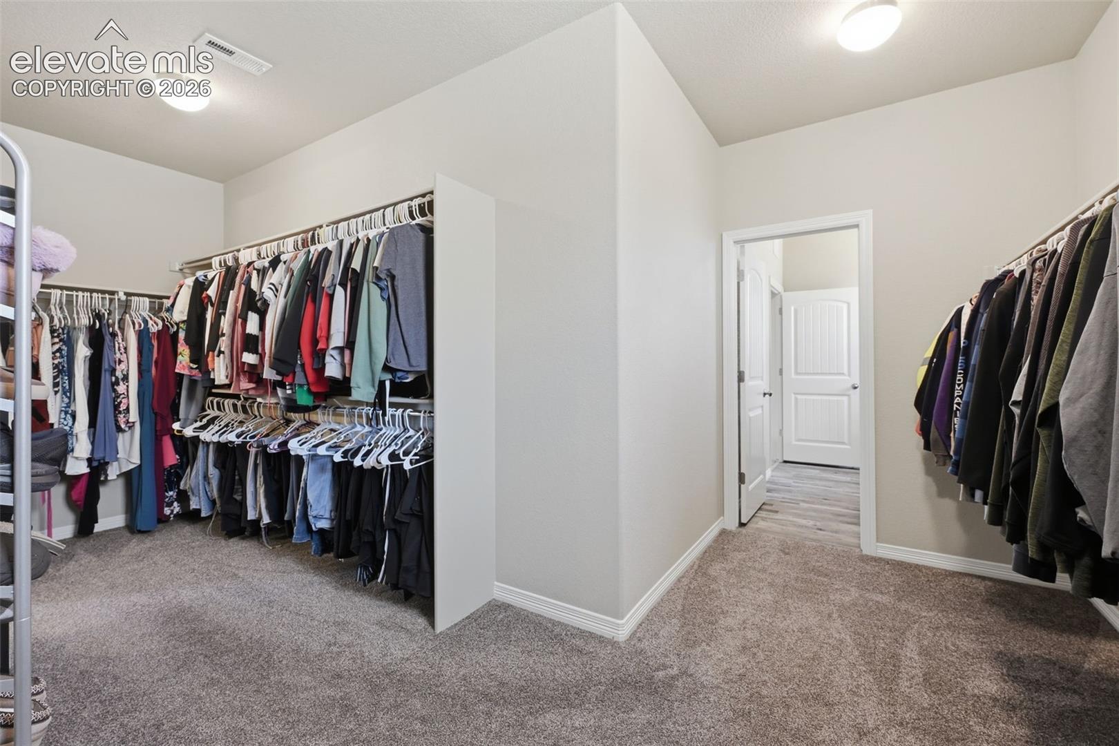 Enormous Primary Walk-In Closet with Direct Access to the Laundry Room