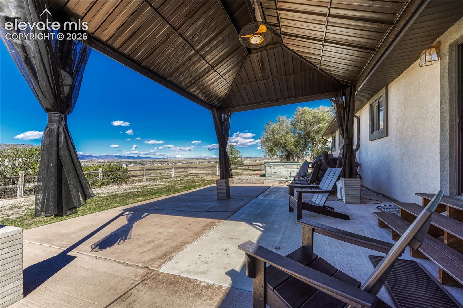 New concrete patio and steel shade structure with mountain views