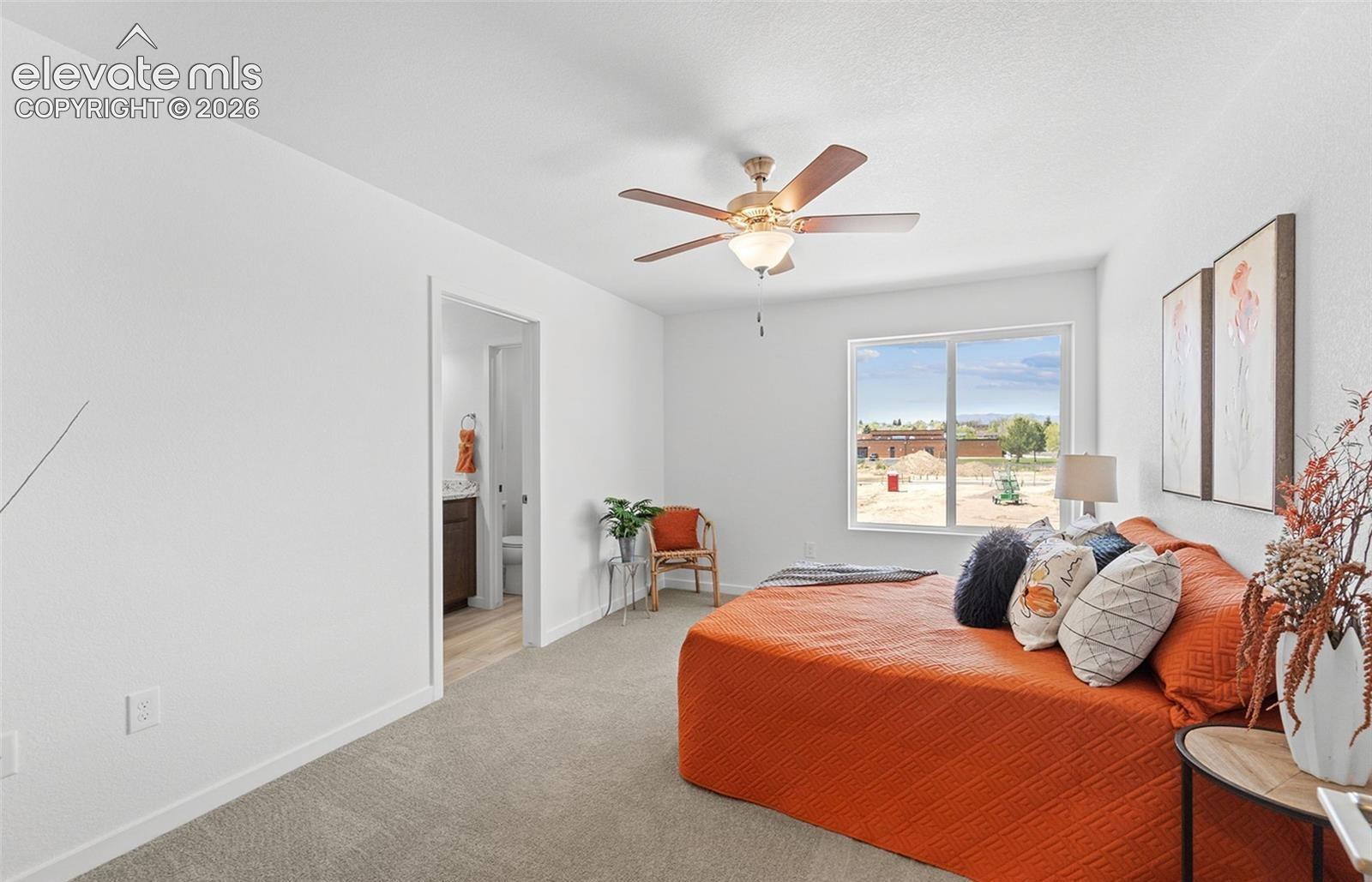Neutral carpeting, five-blade ceiling fan with integrated light fixture, large picture window, and smooth-finish white walls