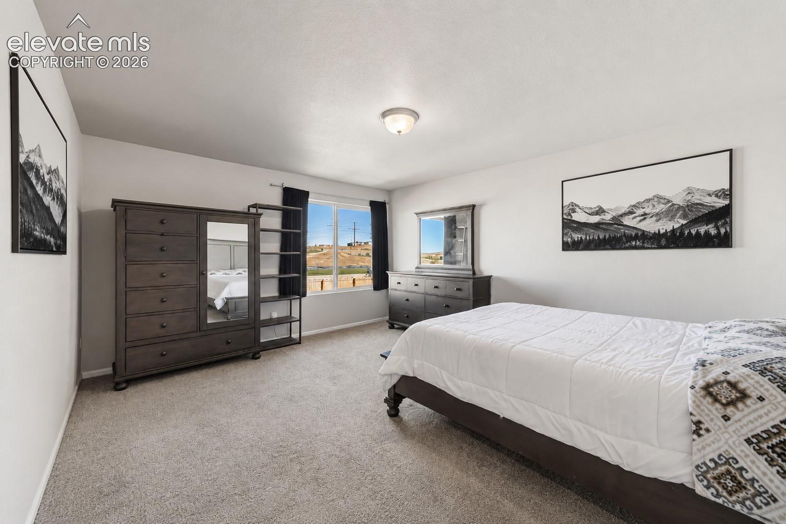 Spacious primary suite with abundant natural light.