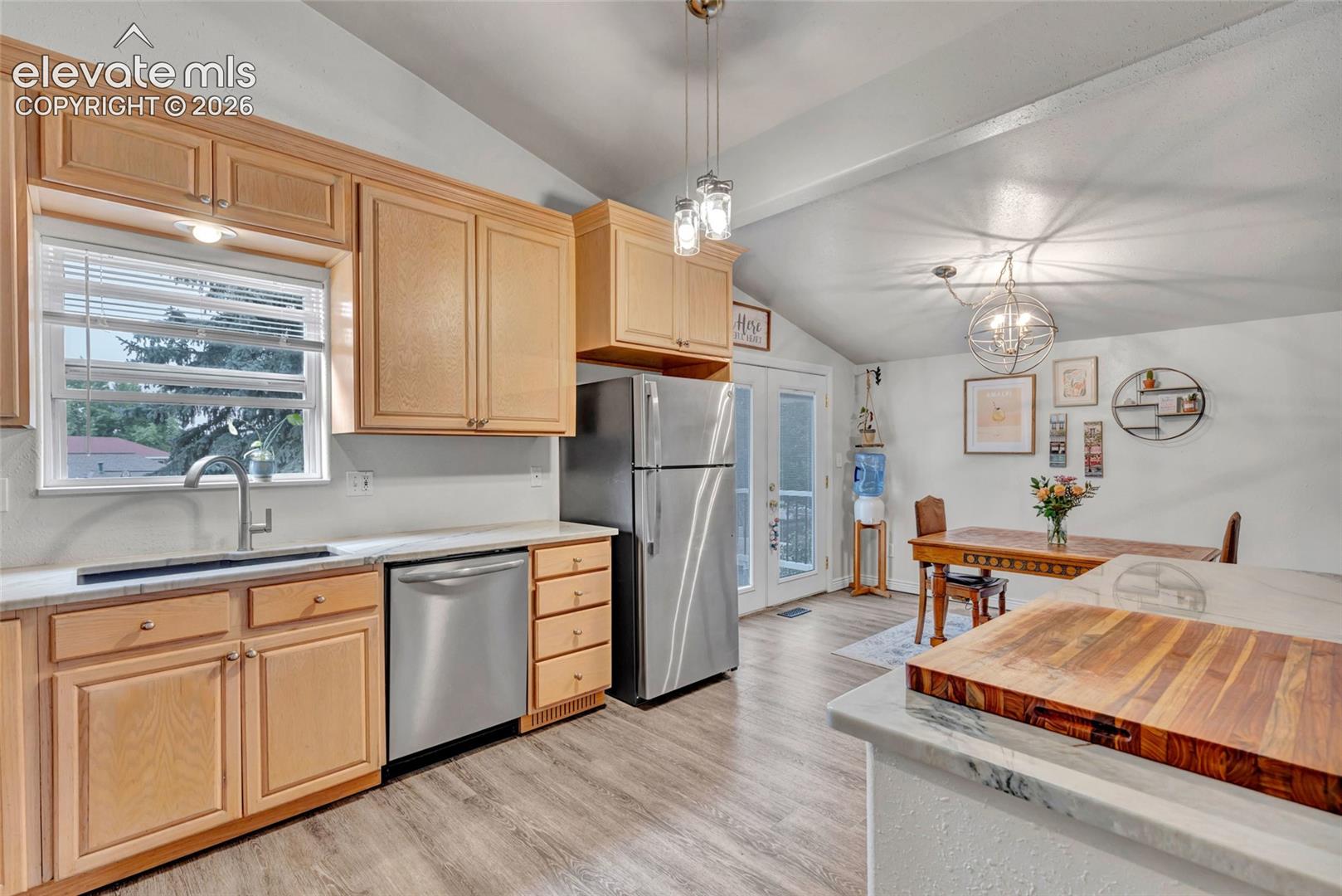 Kitchen featuring wood-finish cabinetry, stainless steel appliances, and light-toned countertops