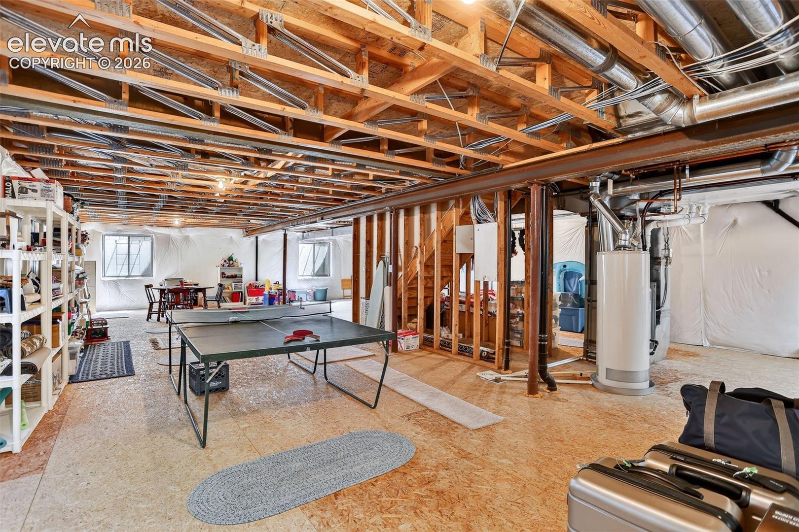 Unfinished basement with exposed wood joists and structural beams