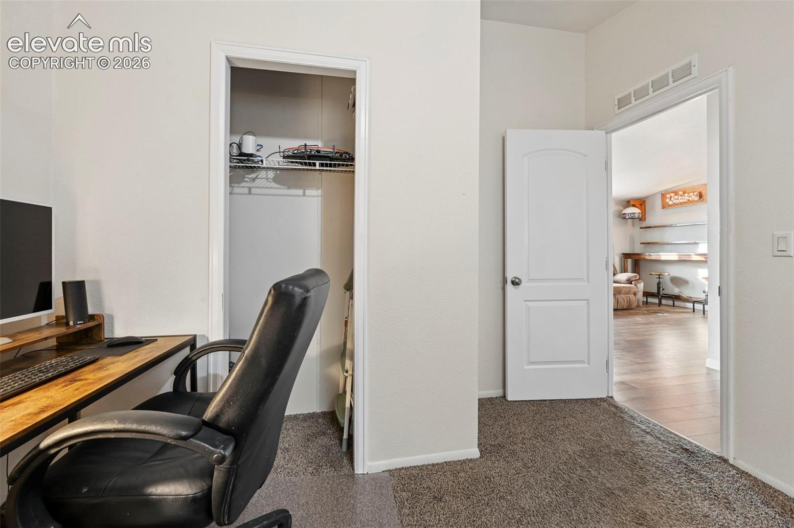 Neutral wall palette featuring an interior closet with wire shelving and a two-panel solid core door