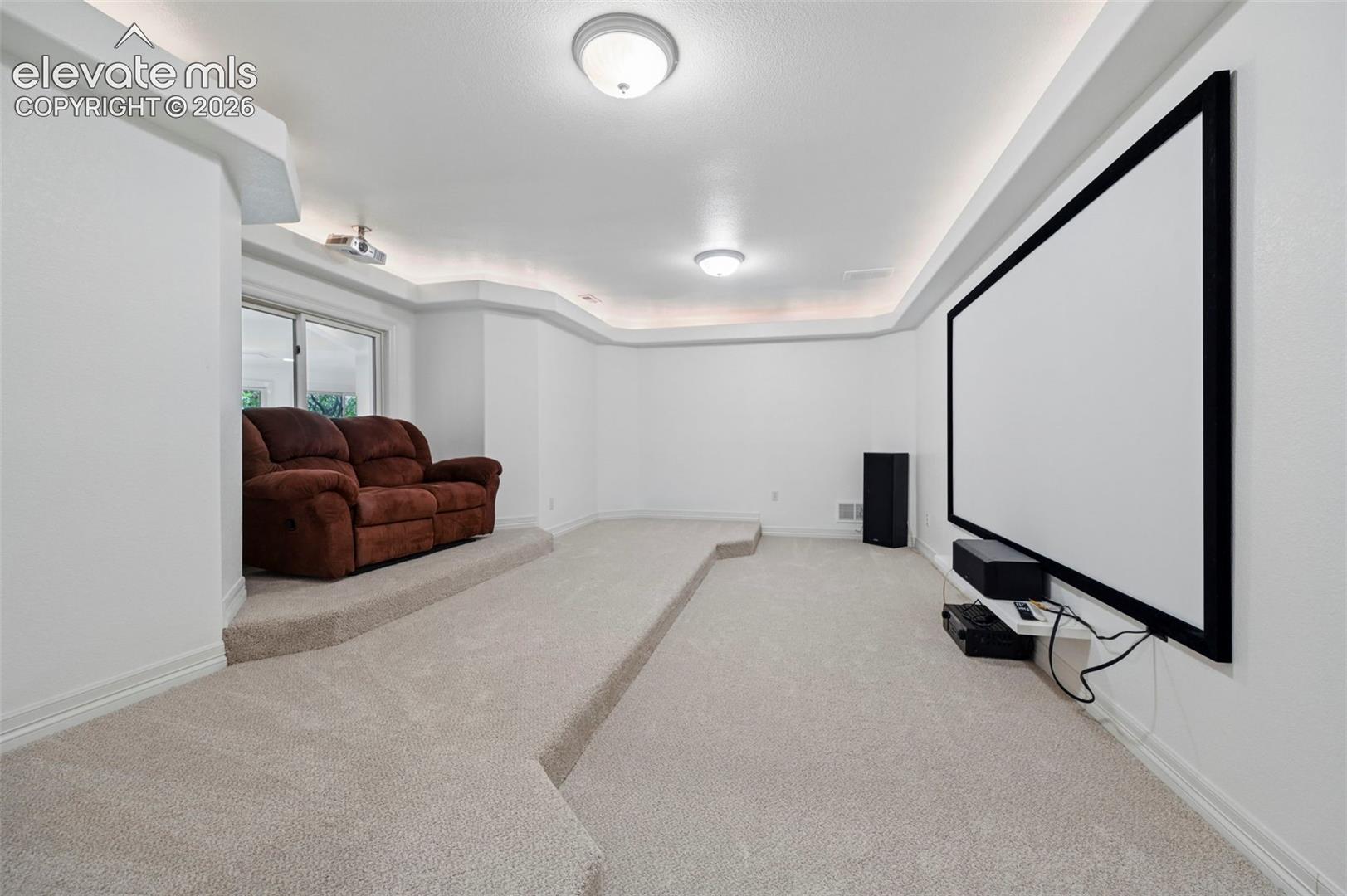 Dedicated media room with tiered seating platforms