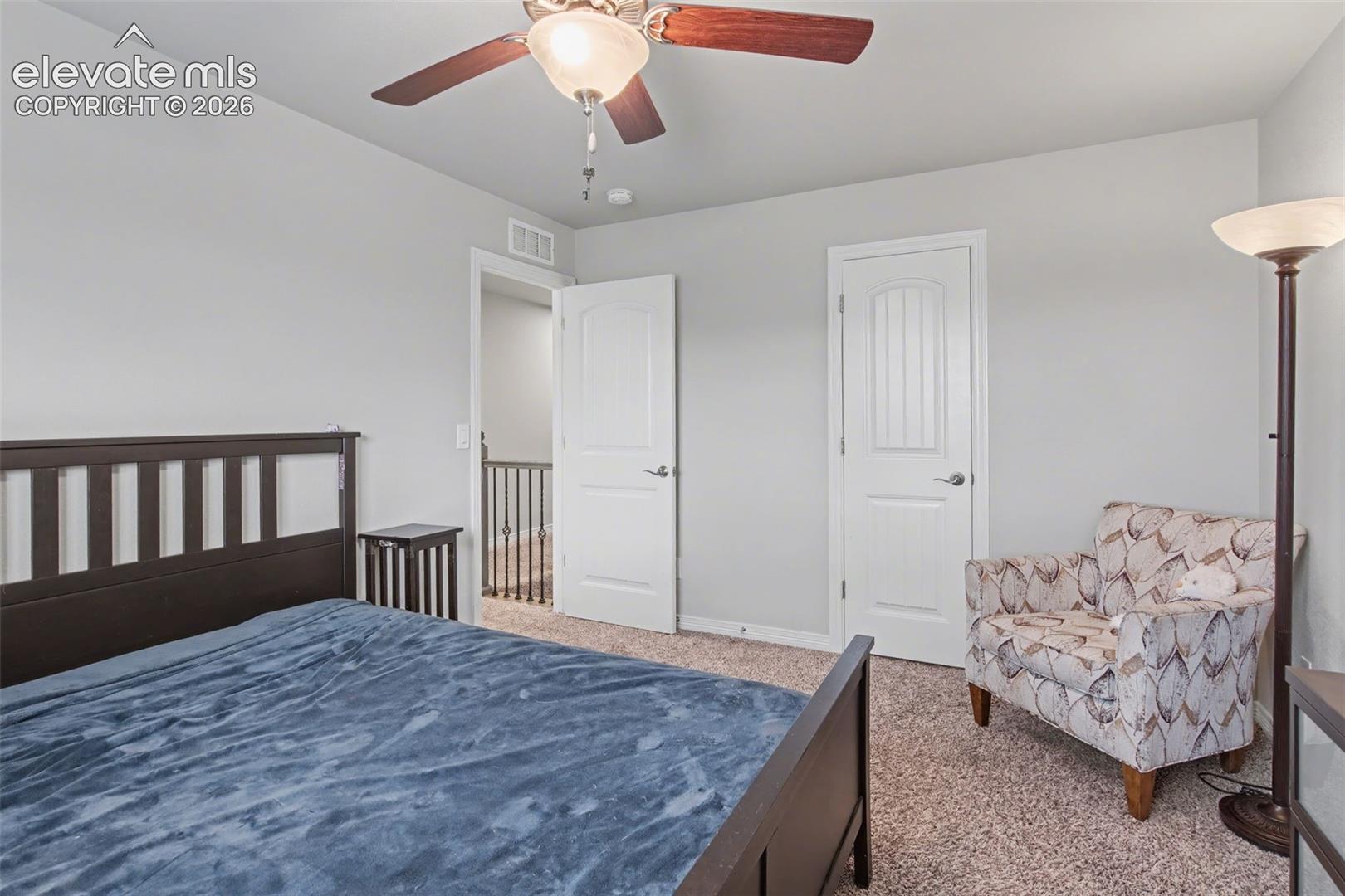 Carpeted flooring, ceiling fan with integrated lighting, and white interior doors