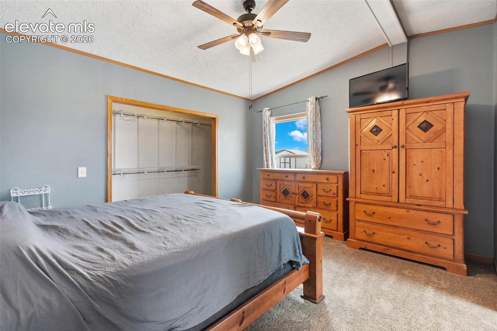Bedroom featuring a ceiling fan, light gray wall color, and carpet flooring