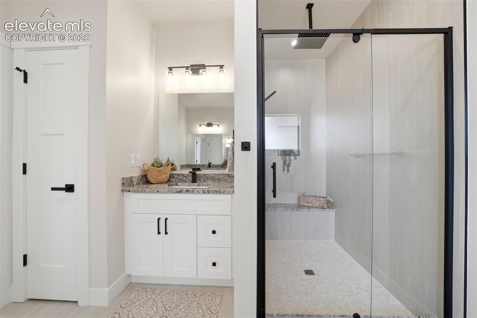 Primary Bath, 2nd vanity and walk in shower with bench.