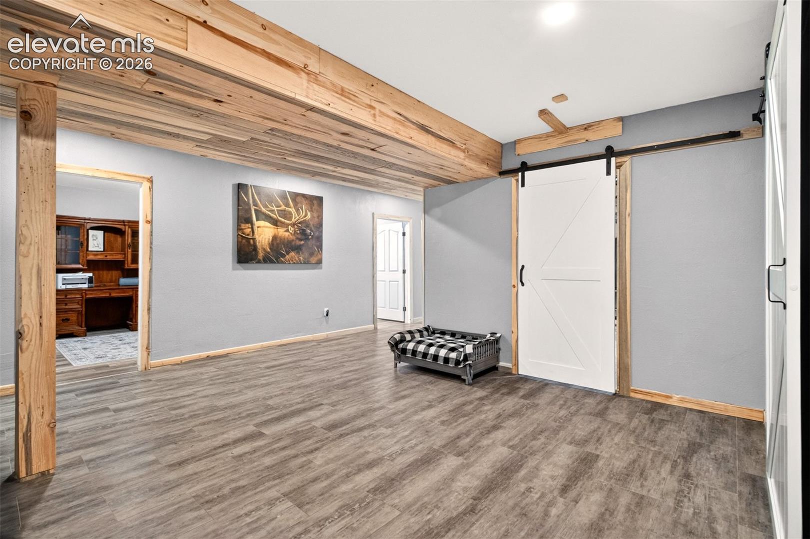 Fully finished, expansive basement showcasing striking beetle kill pine accents that bring distinct Colorado character to the space!