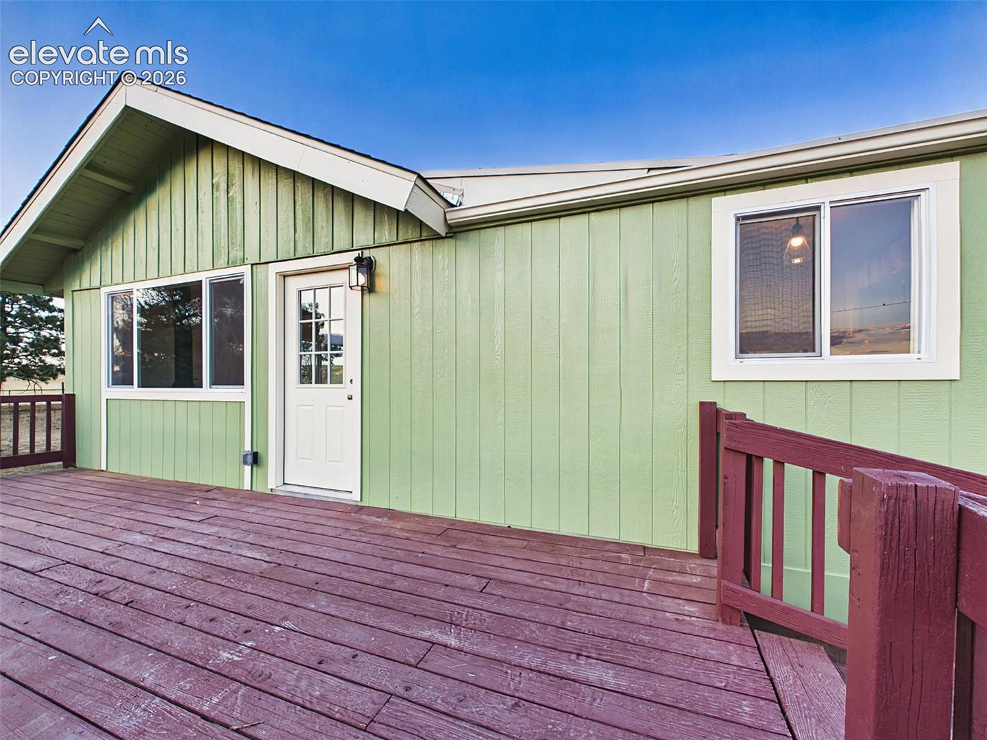 Front Exterior – showcases the home's updated exterior, deck access, and scenic rural surroundings.
