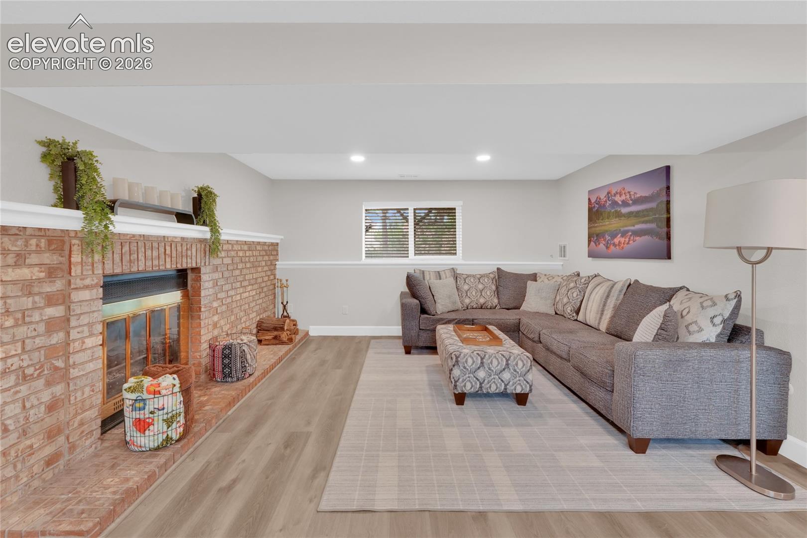 Cozy family room with recessed lighting and fireplace.