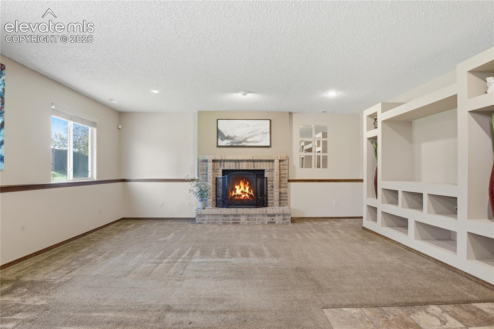 MAIN LIVING AREA INCLUDES A FIREPLACE, BUILT-INS FOR A TV AND ADDITIONAL STORAGE, PLUS A SEPARATE NOOK WITH SPACE FOR AN OFFICE AREA