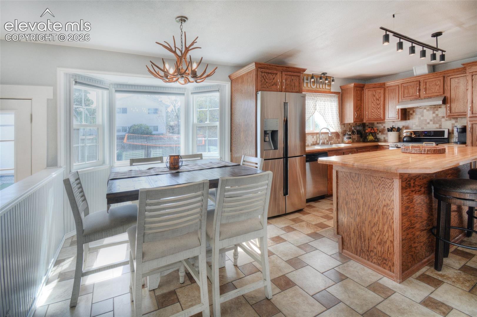 Dining area and kitchen perfect for everyday meals and entertaining. Farm style sink, SS appliances to include double oven gas range with vent hood, refrigerator, dishwasher and microwave.