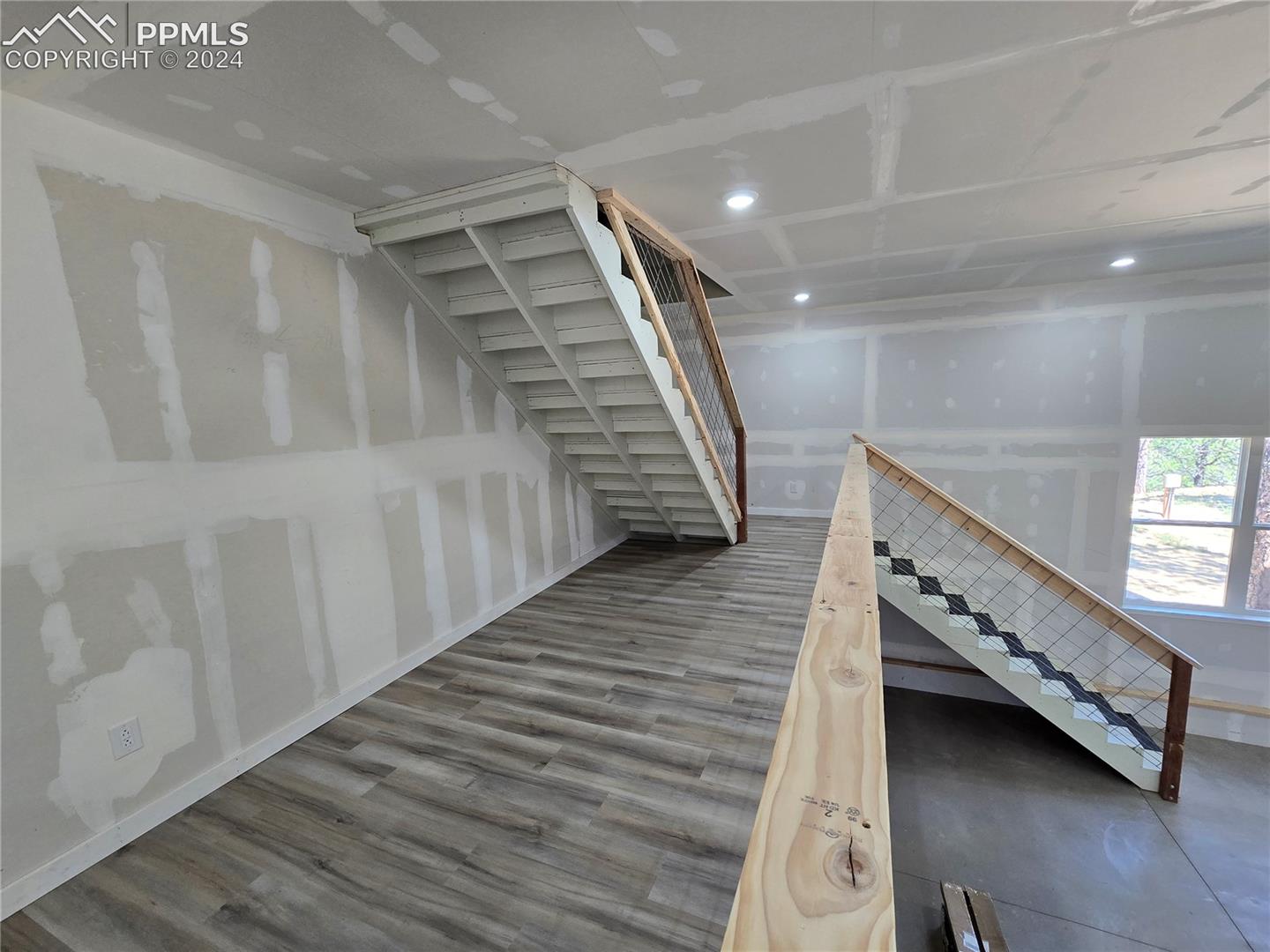 Staircase with hardwood / wood-style floors