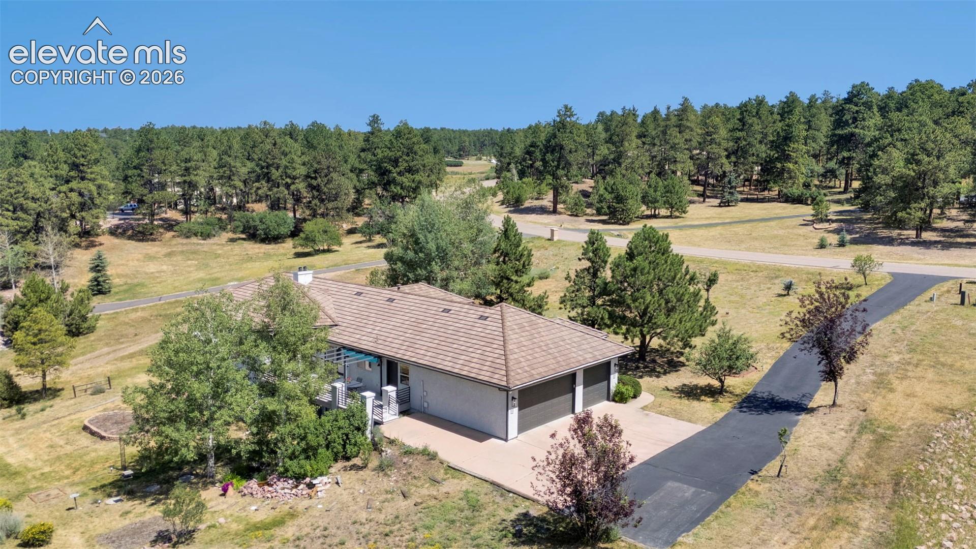 Ranch-style residence featuring an attached two-car garage and a paved driveway