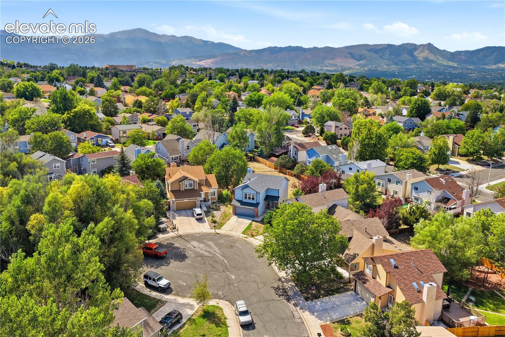 Aerial perspective of a cul-de-sac with mountain range behind