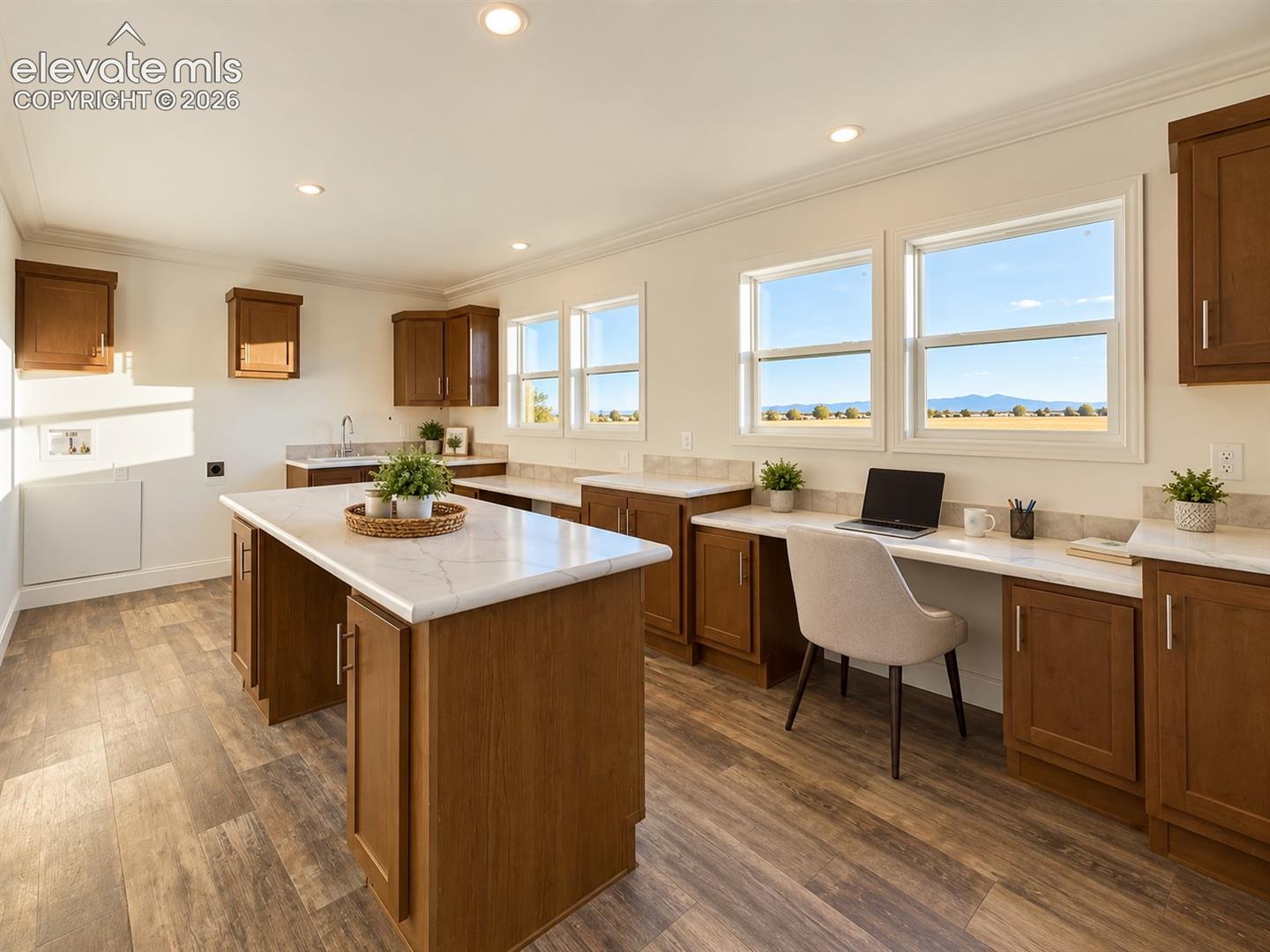 Laundry / Multipurpose Space – Multiple windows bring natural light and expansive views into this exceptionally versatile room, with built-in work surfaces and a large center island offering plenty of space for an office, craft area, hobbies, or household projects.
