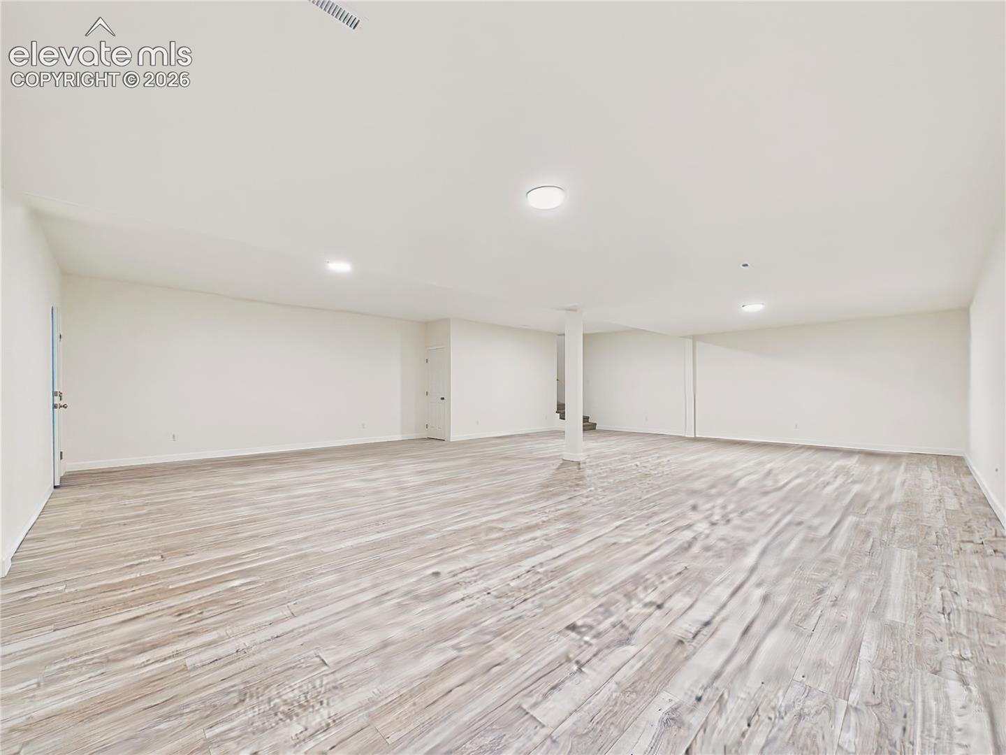 Finished Basement – Another view highlights the basement’s wide-open layout, neutral finishes, recessed lighting, and ample room to customize the space to suit a variety of needs.