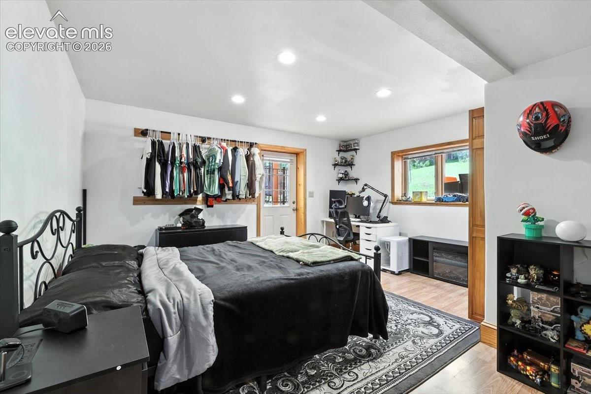 Interior space featuring recessed lighting, wood-finish flooring, natural wood trim, and a glass-paneled exterior door