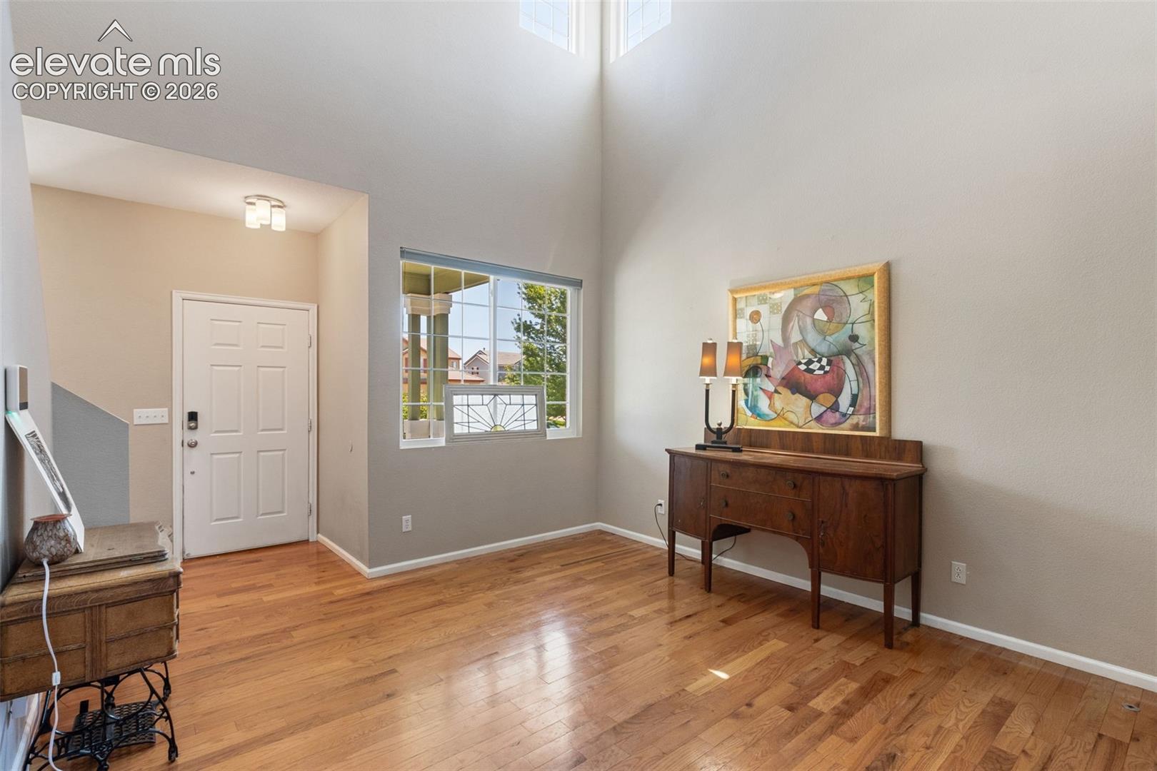 Living room with large windows and view of patio.