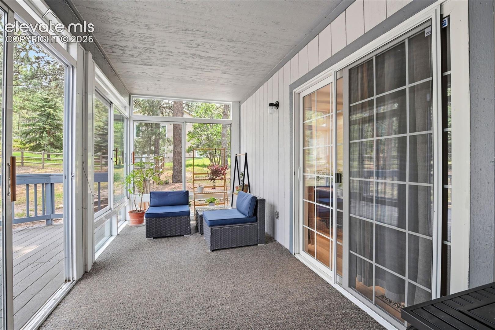 Sun room / screened-in porch just off the main level living room addition.
