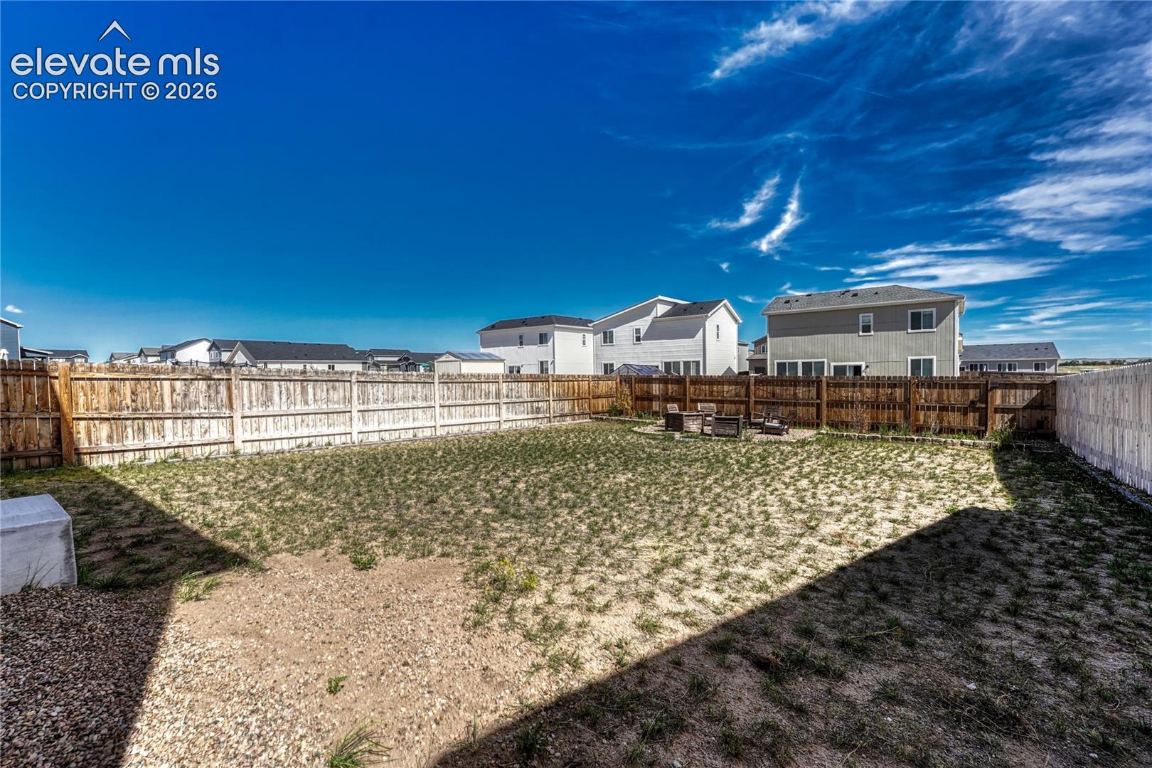 Large, flat fenced yard.