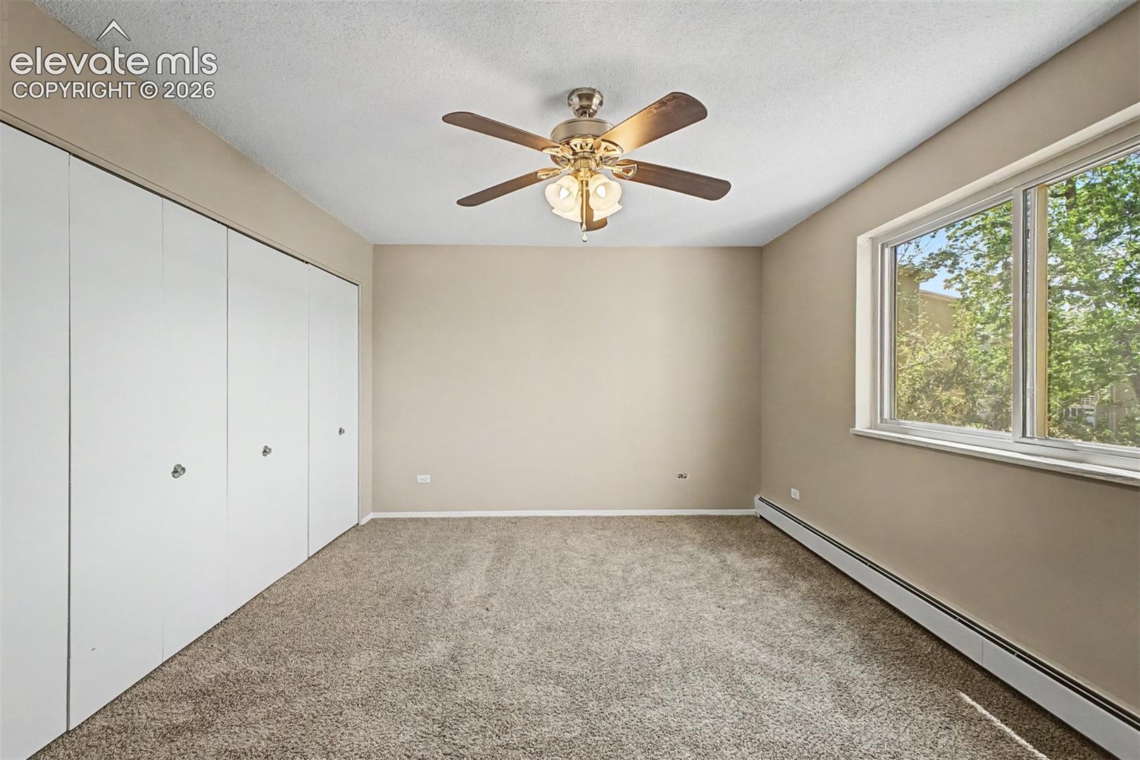 Room with neutral-toned carpeting and light beige wall paint