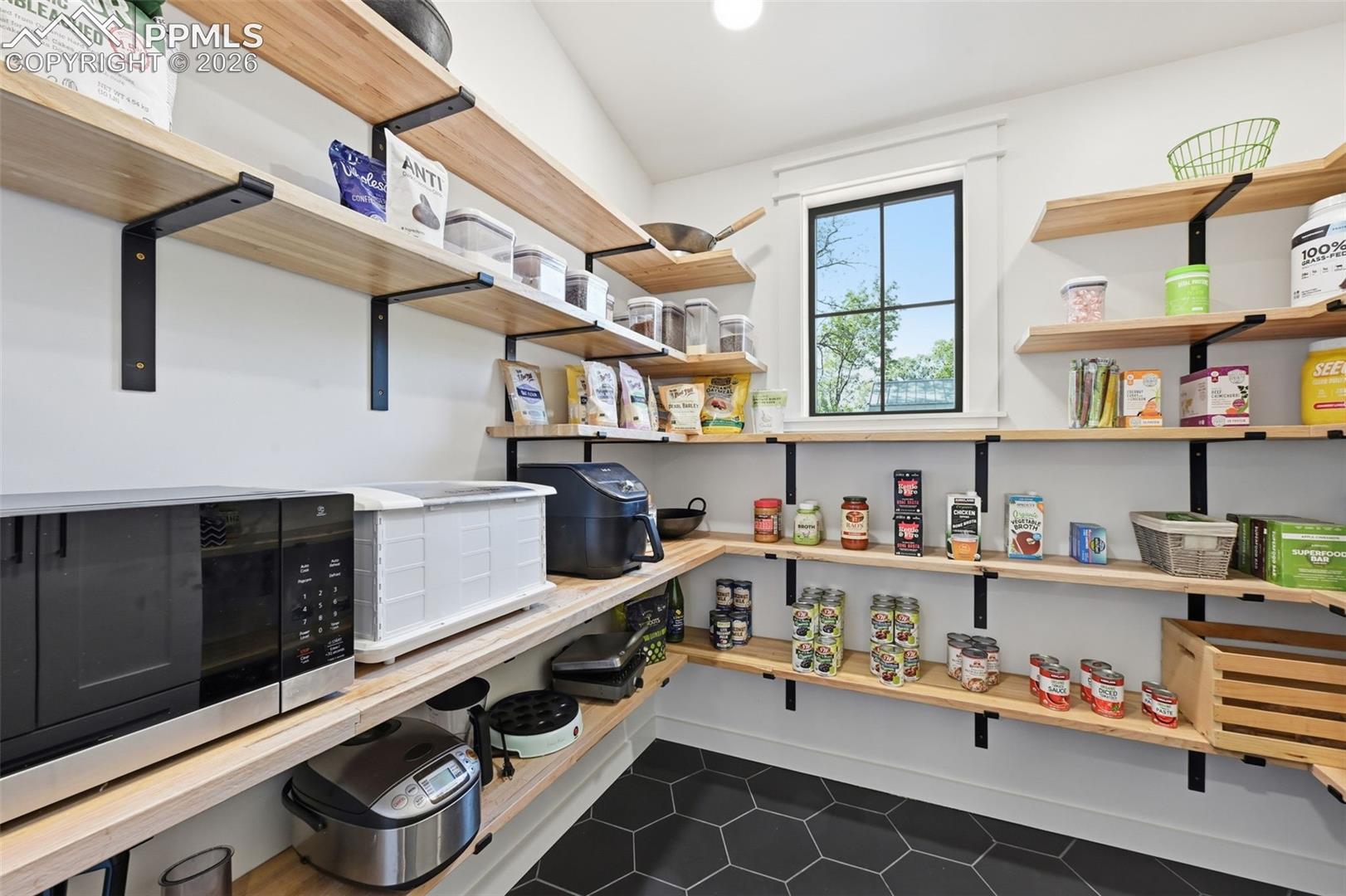 Walk-in pantry with natural light and heated floors.
