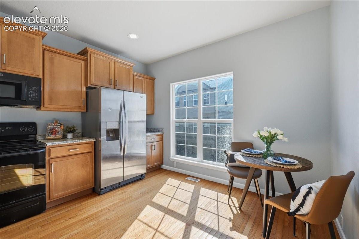 Kitchen space featuring wood flooring, ample cabinetry, and mountain views
