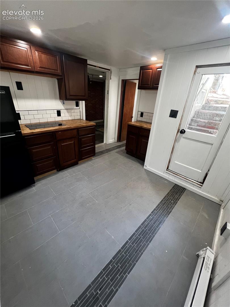 Lower Apt: Exterior door leads to stairs. Shared water heater with upper apartment