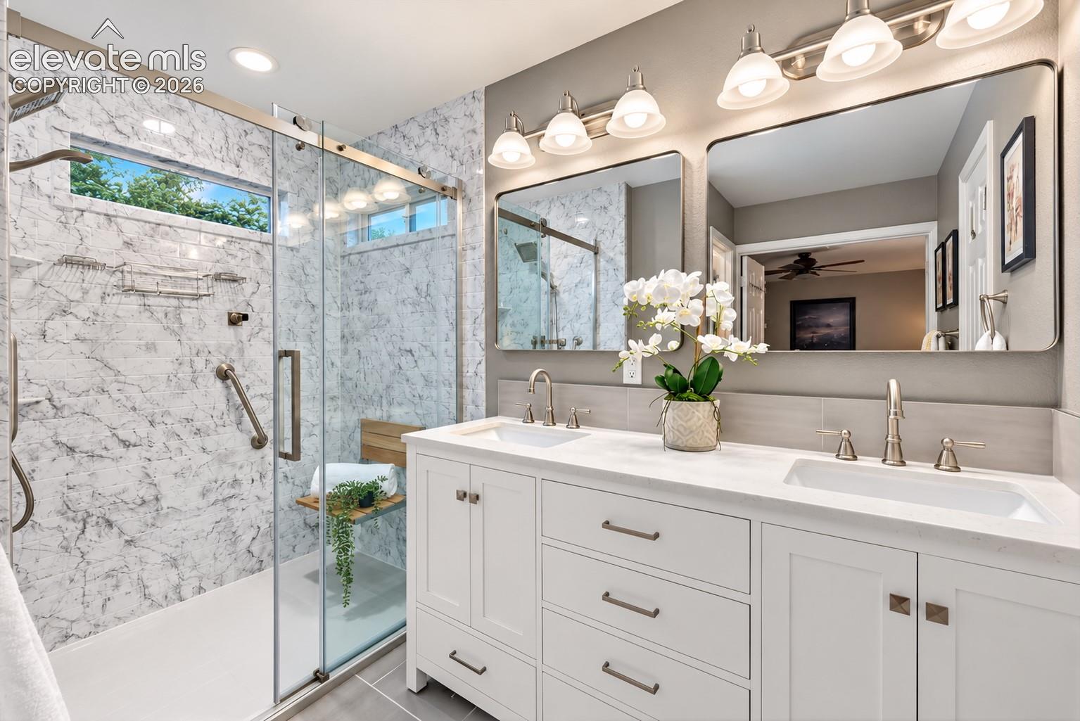 The beautifully updated primary bath pairs clean contemporary finishes with everyday functionality.