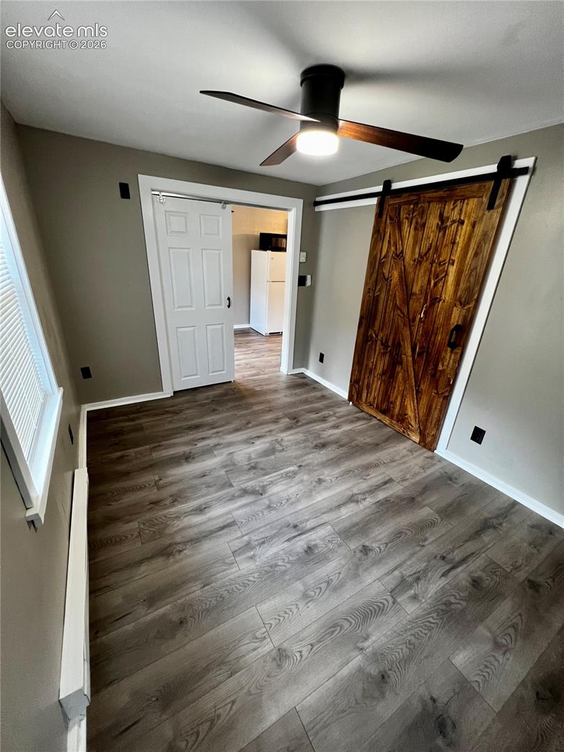  Upper Apt: View of bedroom towards living room. Dual sliding barn doors