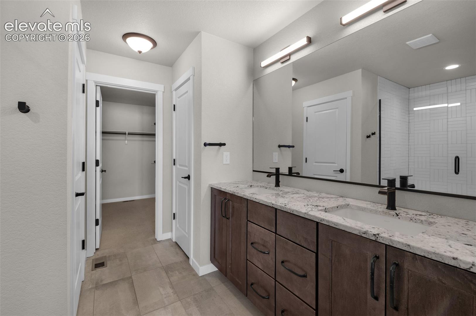 Dual vanity with wood-finish cabinetry and light-toned countertops