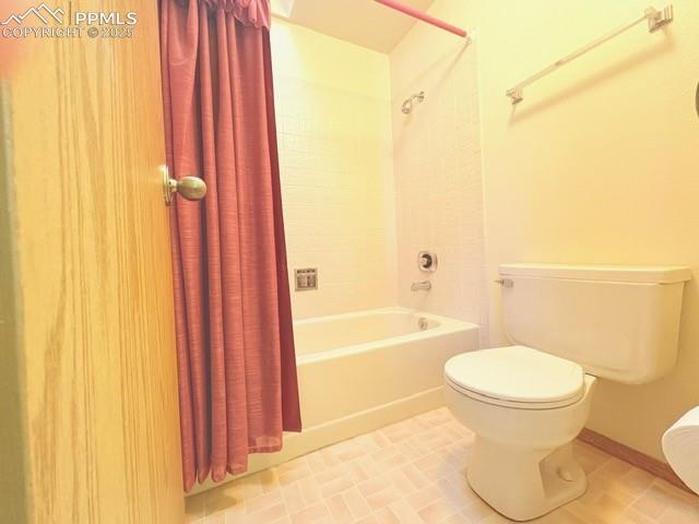 Bathroom featuring shower / bath combo and light tile patterned floors