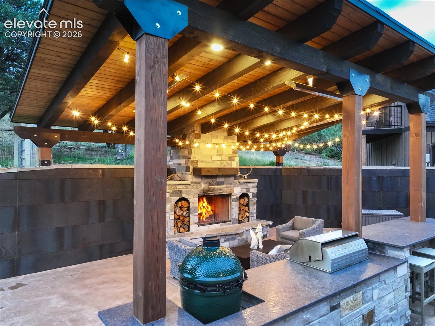 Covered patio w/ fireplace, built-in grill & fridge