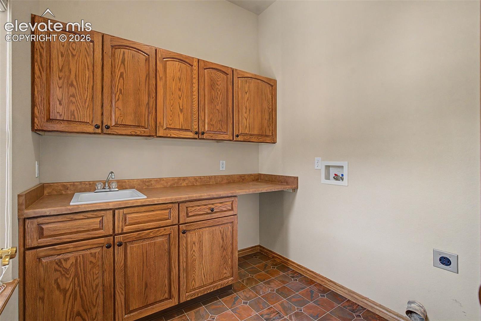 Laundry area with sink