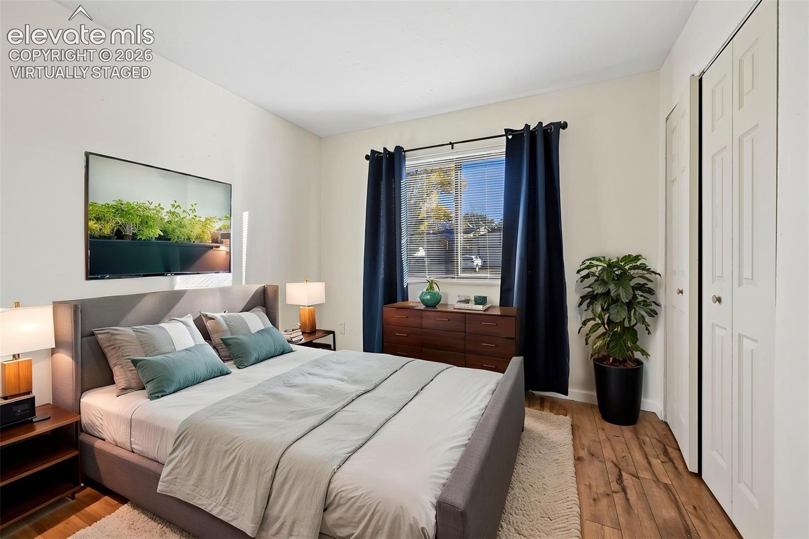 Virtually staged secondary bedroom on main floor with LVP floors