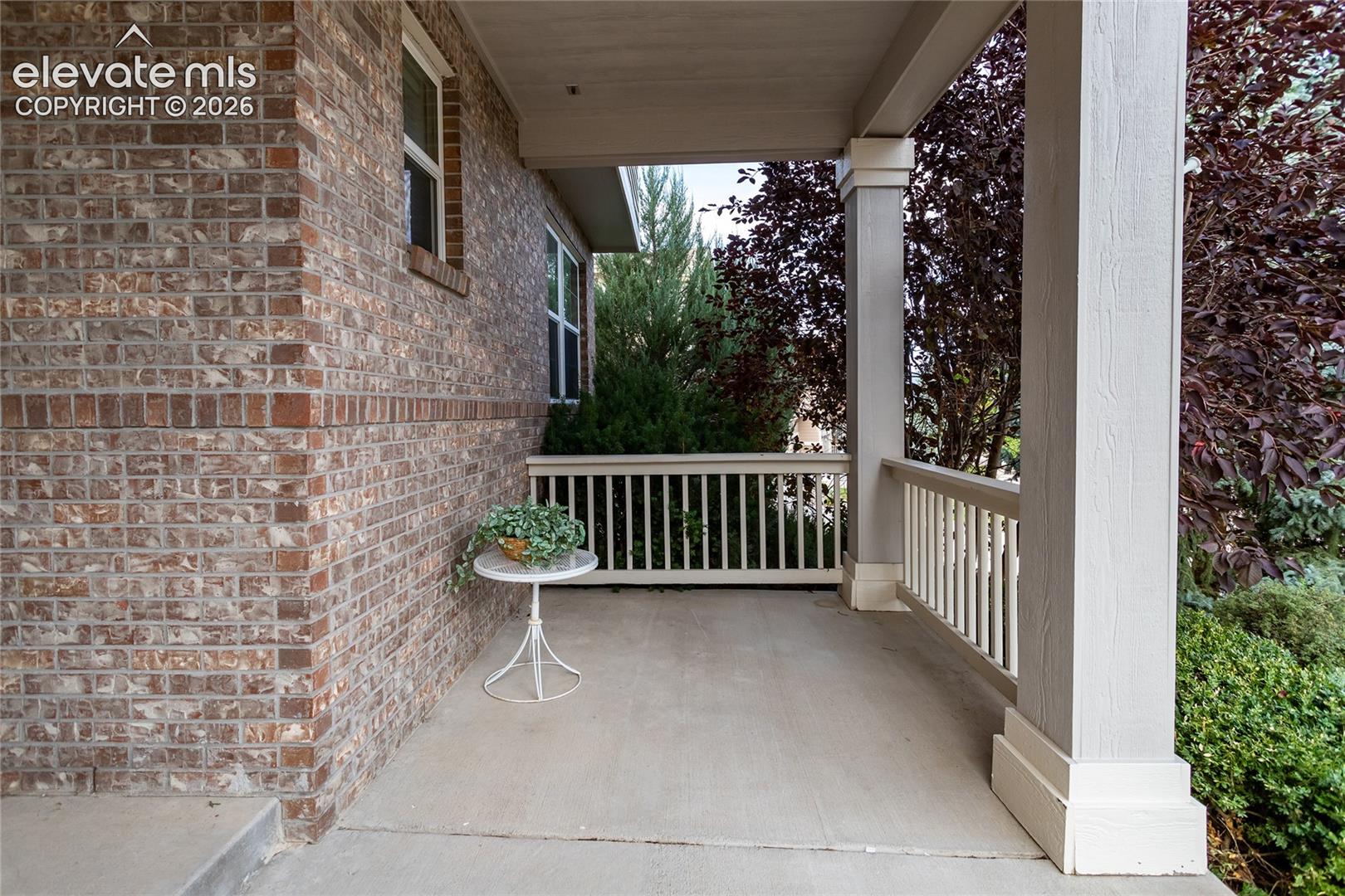 Covered front porch is surrounded by beautiful landscaping!