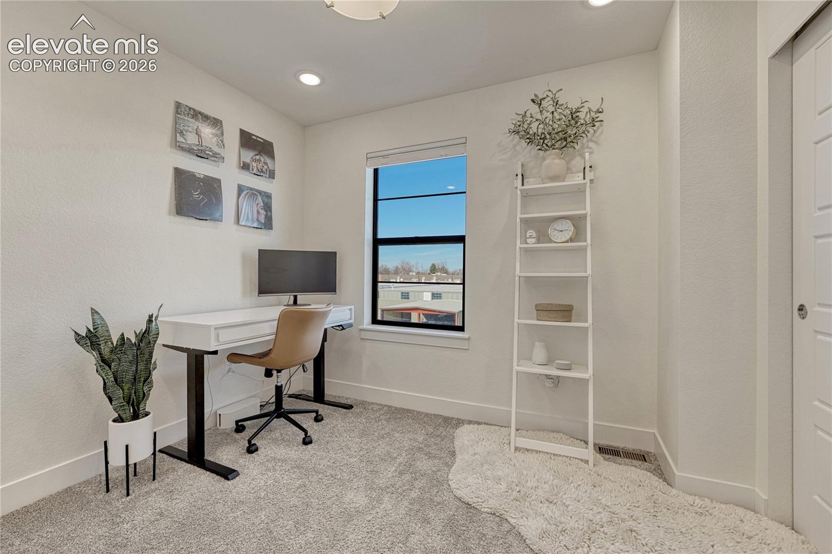 Room featuring neutral wall-to-wall carpeting, a single-hung window with black framing, and recessed ceiling lighting