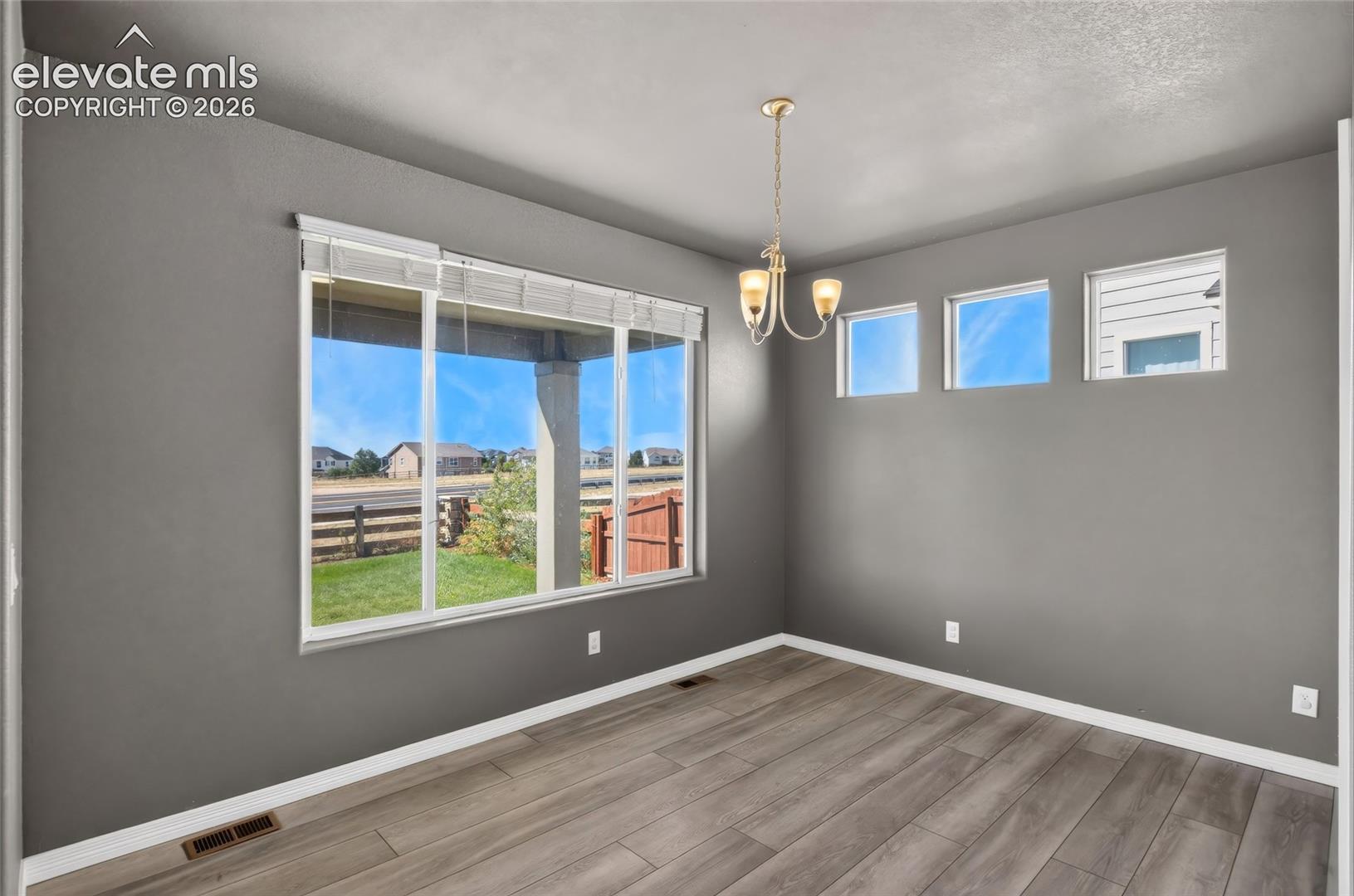 Hardwood-finish flooring, recessed lighting, and a multi-pane window with blinds, eat in Kitchen