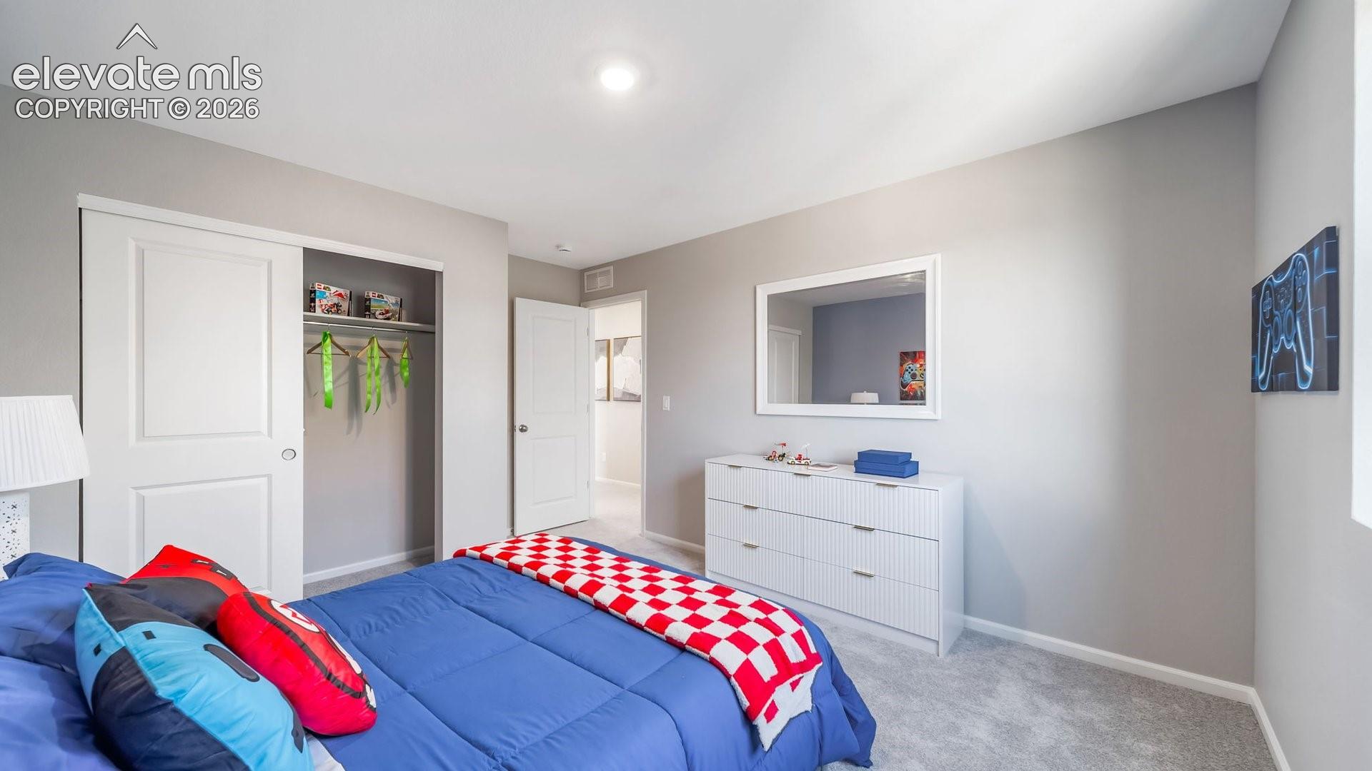 Bright secondary bedroom featuring neutral wall finishes, recessed ceiling lighting, and light wood-finish flooring
*photos of a model home*