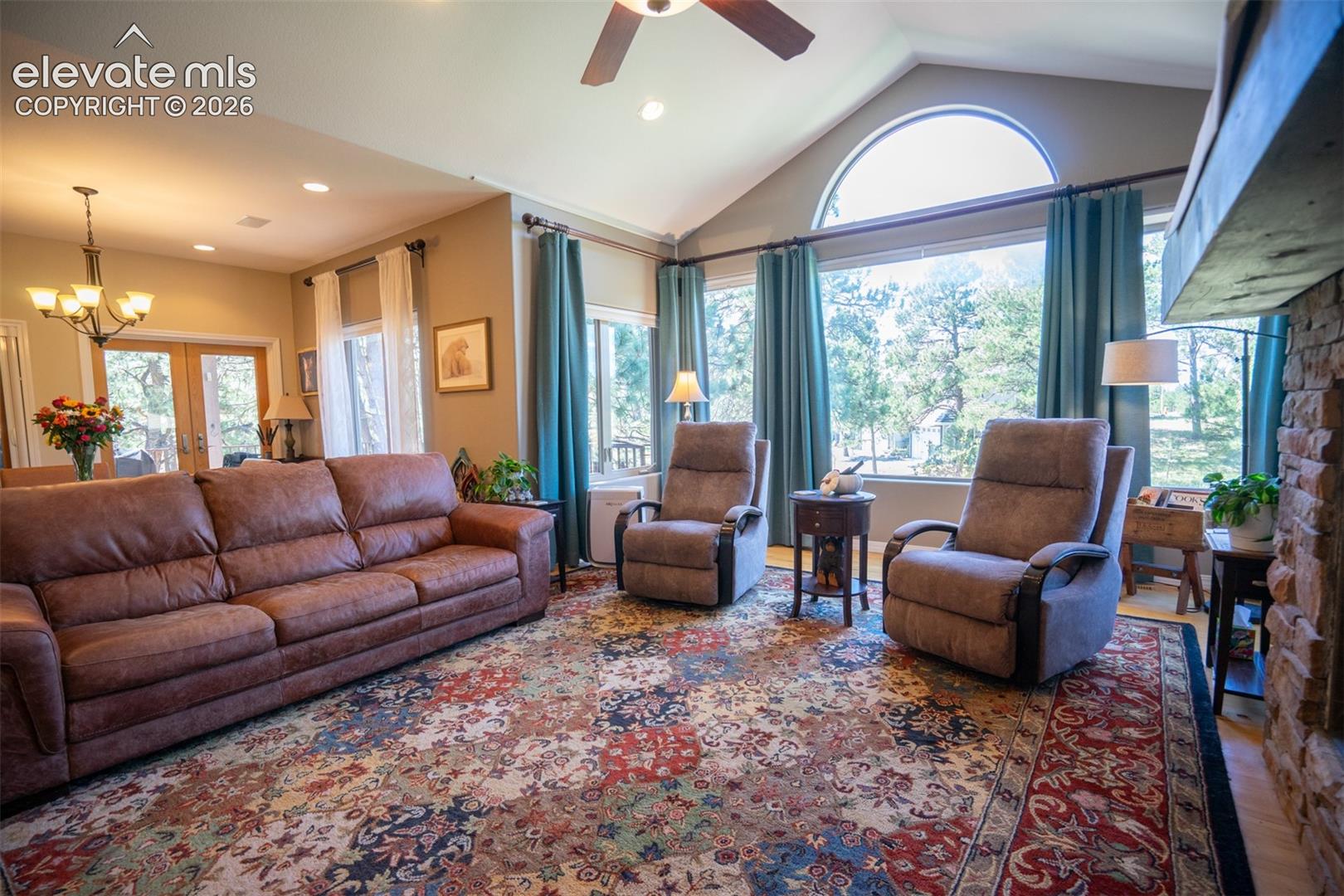 Notice the openness between the living room and dining area is open and bright with multiple windows to capture nat'l light and the views