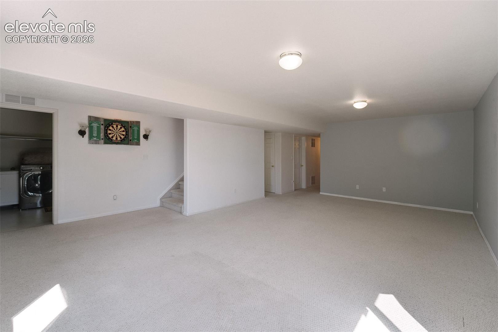 Large Basement Family Room with neutral carpet.