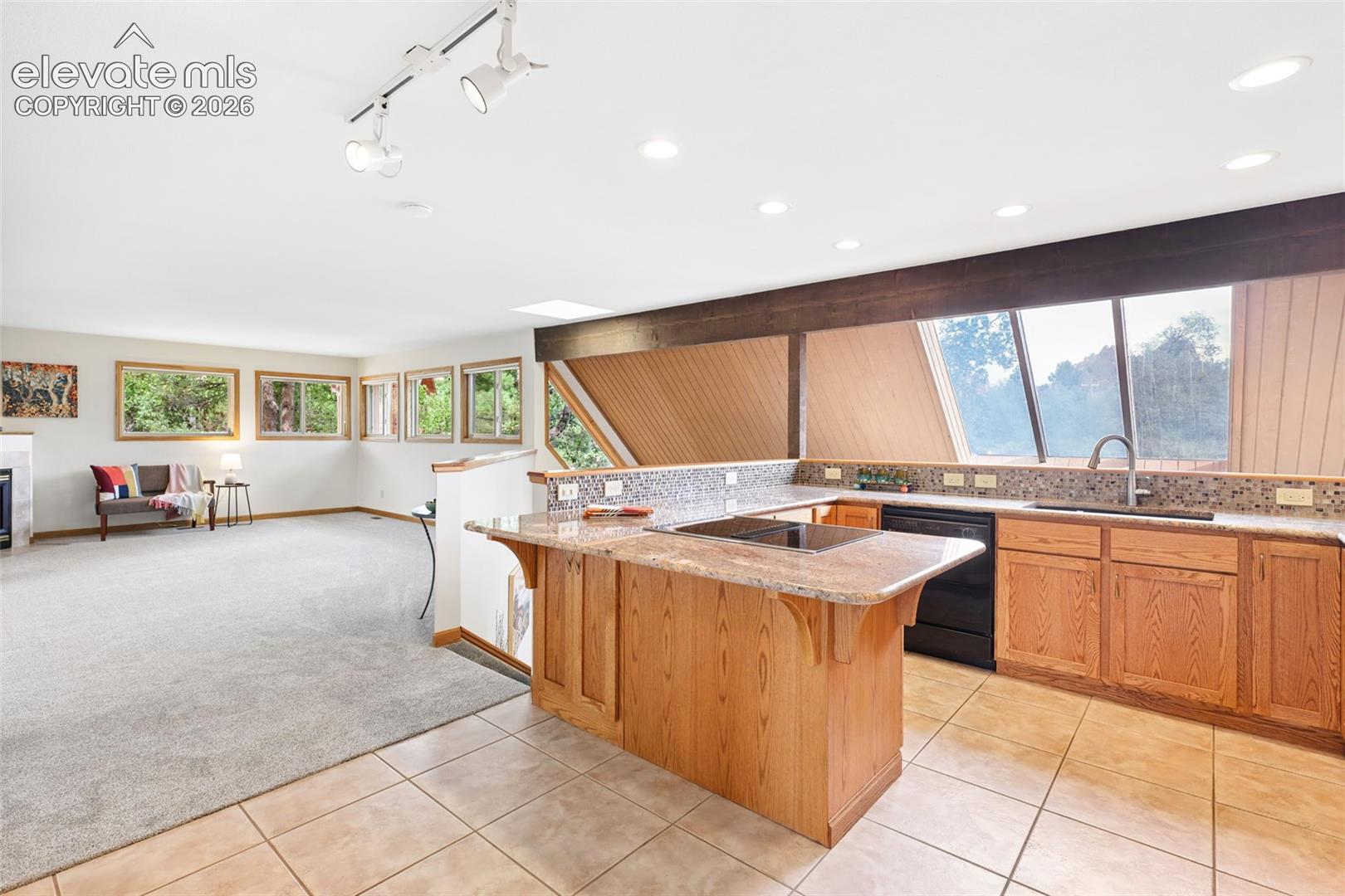 The kitchen showcases exquisite granite, kitchen bar, and top-rated Jennaire appliances.