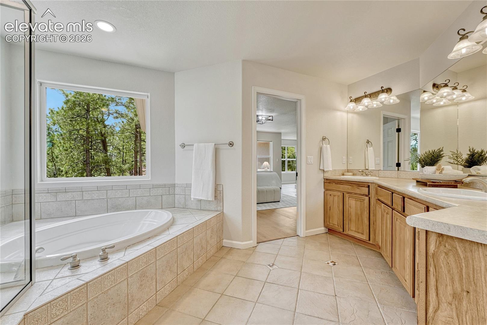 Adjoining 5-piece bath with double vanity, soaker tub...