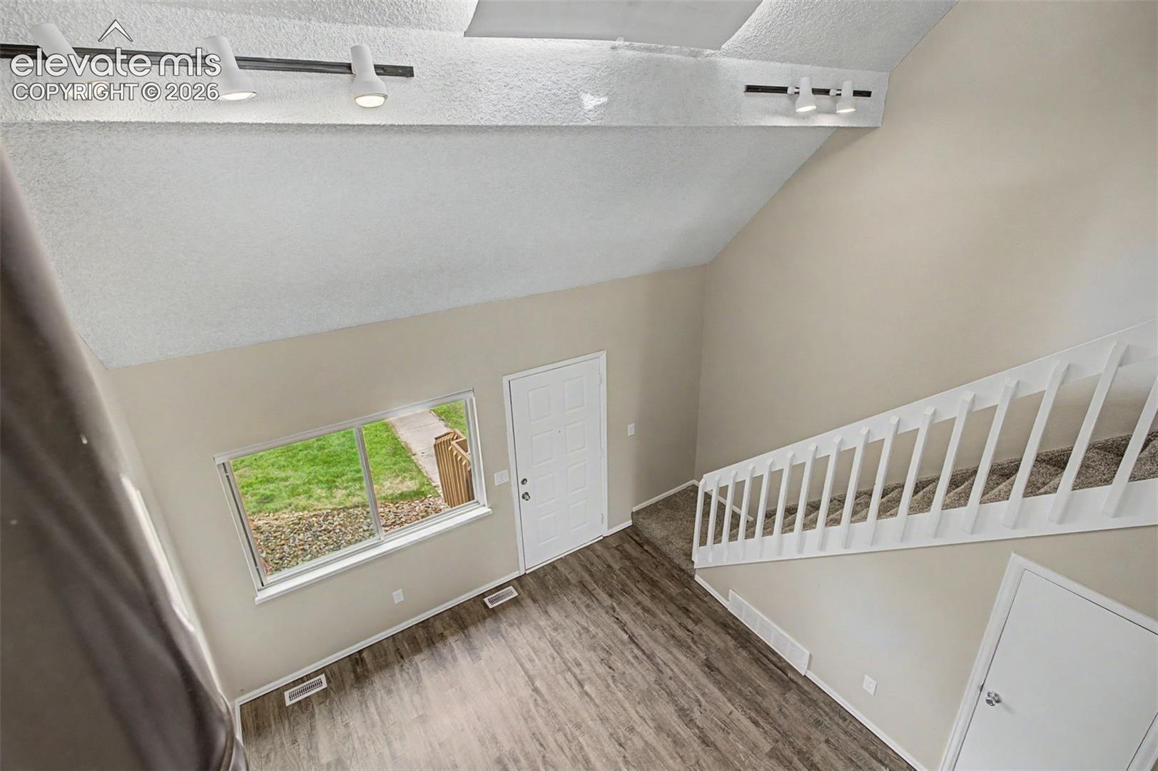 Vaulted ceilings and large windows provide depth allow for the home to feel open and brightly lit with natural lighting!